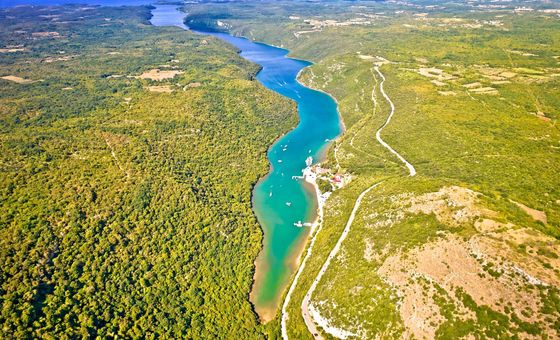 Lush green cliffs and calm waters of the Lim Channel fjord